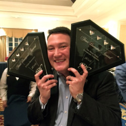 Anthony Carey holding Four Diamond award for The Siena Hotel and Il Palio